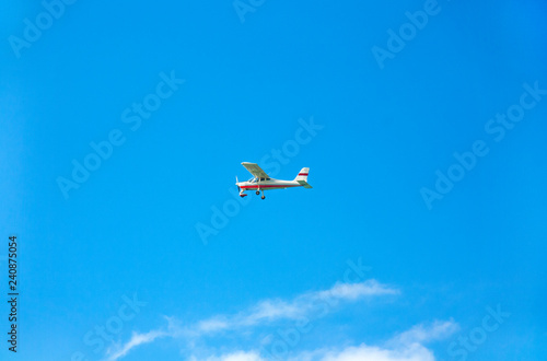 Light aircraft on blue sky as background
