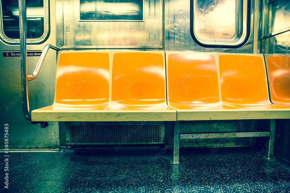 View inside New York City subway train car with vintage orange color seats