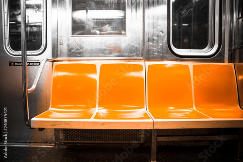 View inside New York City subway train car with vintage orange color seats © littleny