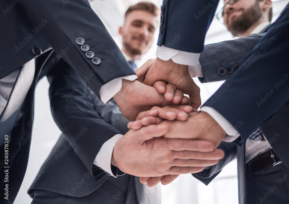 close up.business team adding a tower of hands