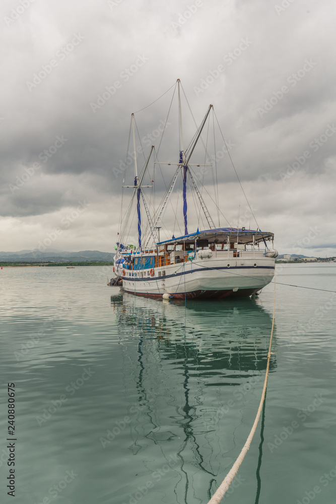 Sailing Boat, Sailboat at Mactan Strait, Mactan, Cebu, Lapu Lapu, a Tranquil scene with a calm sea, seascape, a nice Yacht tied with a rope and reflection in the water Sailing Boat, Sailboat at Mactan Strait, Mactan, Cebu, Lapu Lapu, a Tranquil scene with a calm sea, seascape, a nice Yacht tied with a rope and reflection in the water