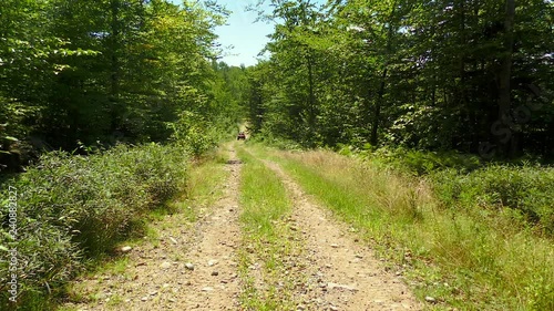 ATV Pulls In on Dirt Road Mountain trail Maine