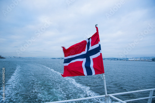 Norway's floating flag captured by wind at sea during sailing.