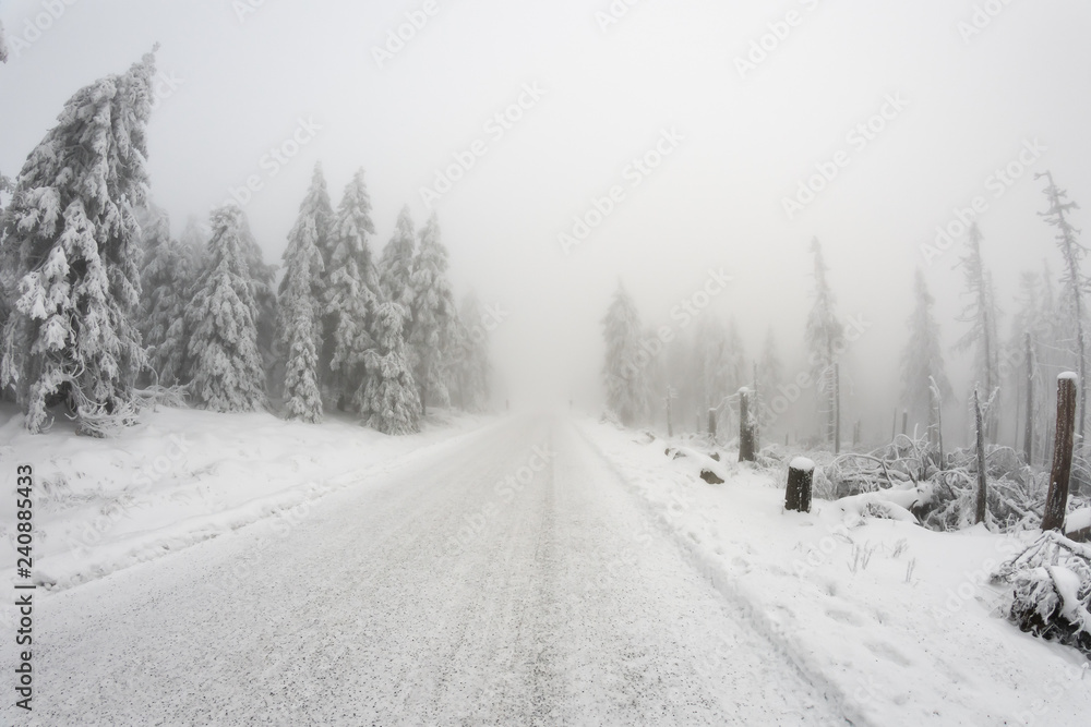 Fototapeta premium Snow covered road uphill a mountain
