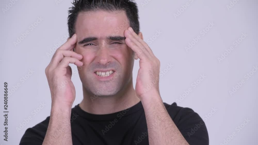 Face of stressed man having headache against white background Face of stressed man having headache against white background