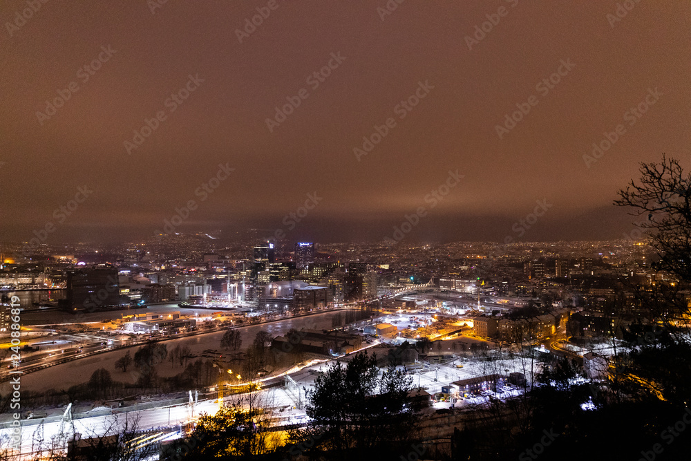 Overlooking the city center of Oslo Norway during the winter all covered with fresh snow during the evening time
