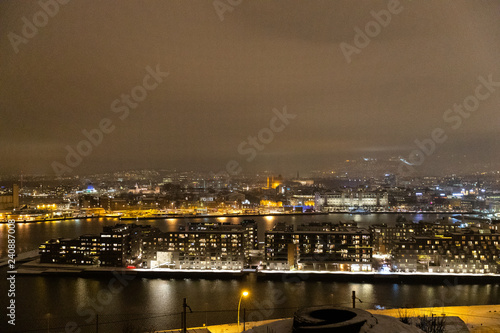 Overlooking the city center of Oslo Norway during the winter all covered with fresh snow during the evening time