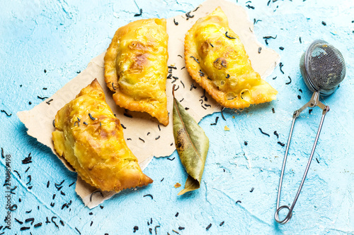 algerian meat bourak named bourek laajine on paper decorated with herbal and green rosemary. photo