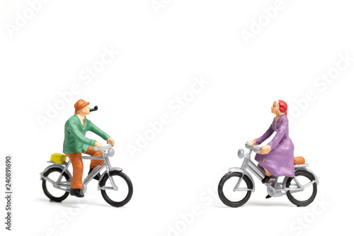 Miniature people : Couple ride bicycle on white background