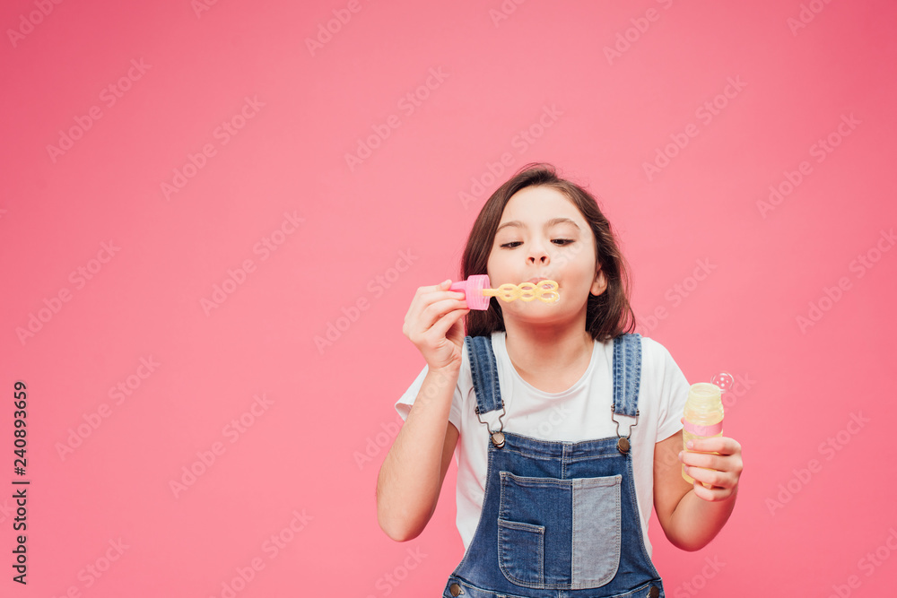 funny kid blowing soap bubbles isolated on pink funny kid blowing soap bubbles isolated on pink