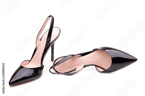 Black patent leather shoes with a sharp toe. A pair of black shoes with high heels.