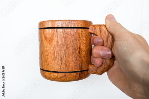 Wooden Tea Coffee Mug Holding with Hand On White photo