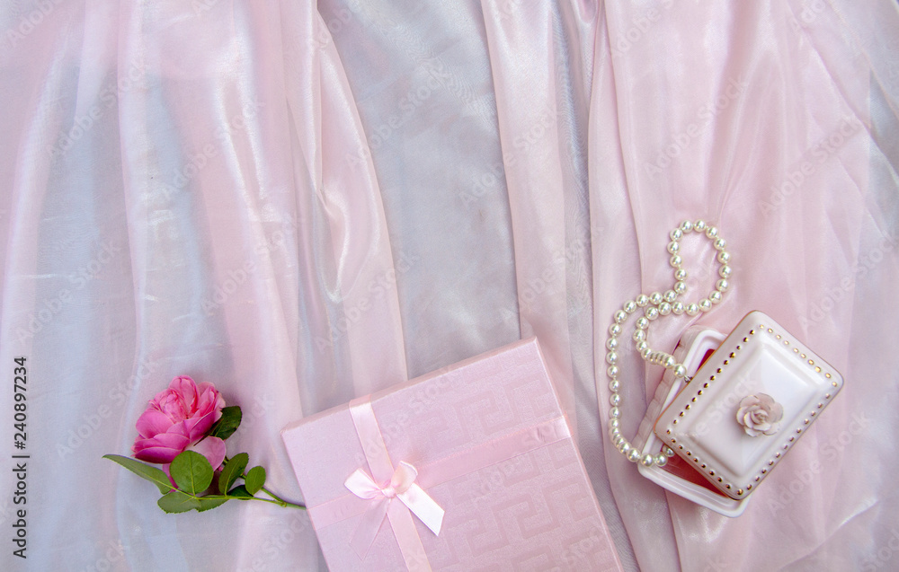 pink background with a box and pearl beads pink background with a box and pearl beads