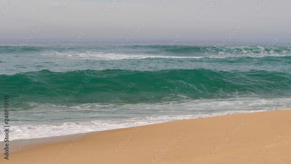 Slow motion Atlantic ocean waves reaching sand shore with splashes shot in west Portugal Slow motion Atlantic ocean waves reaching sand shore with splashes shot in west Portugal