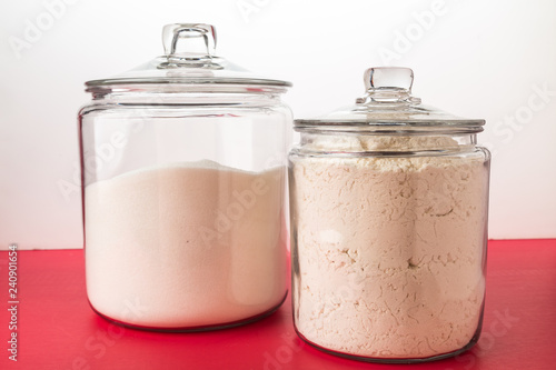 Sugar and Flour Cannisters on Red Counter with White Background