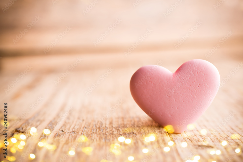 Living coral heart candy on a wooden background. Valentines day greating card. Living coral heart candy on a wooden background. Valentines day greating card.