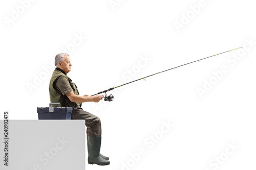 Mature man sitting and fishing