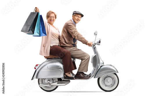 Senior couple with shopping bags on a vintage scooter