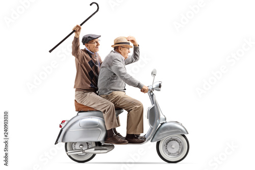 Two senior men riding a vintage scooter and waving with a cane