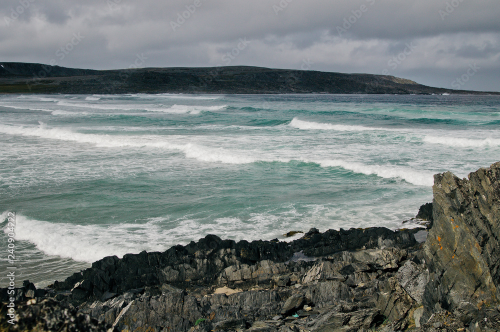 The stone coast of northern Norway and the waves of the Barents Sea