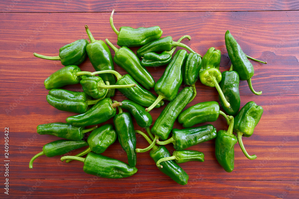 Padron peppers green on a wooden table Padron peppers green on a wooden table