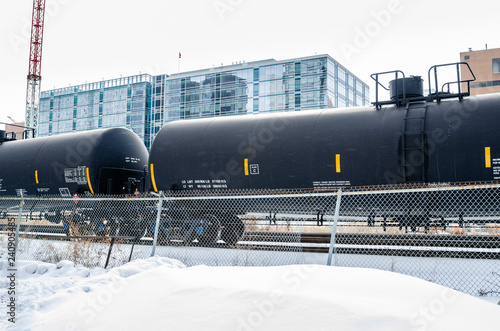 Train of Tank Railcars in a Snowy Freigh Terminal on a Winter Day photo