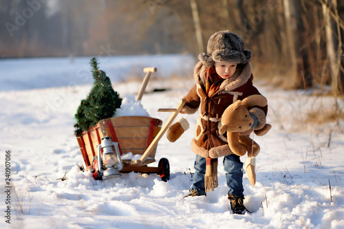 Child in winter. Fun little boy in the snow. The child is playing outside. Winter background. Beautiful, original winter photos. photo