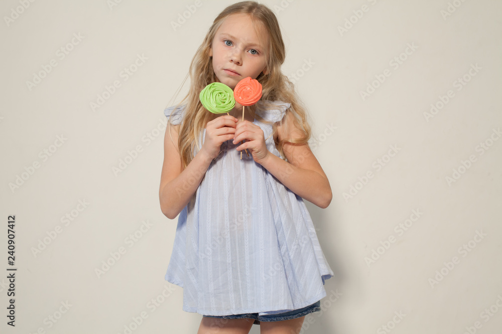 little girl eating sweet candy lollipop on a stick little girl eating sweet candy lollipop on a stick