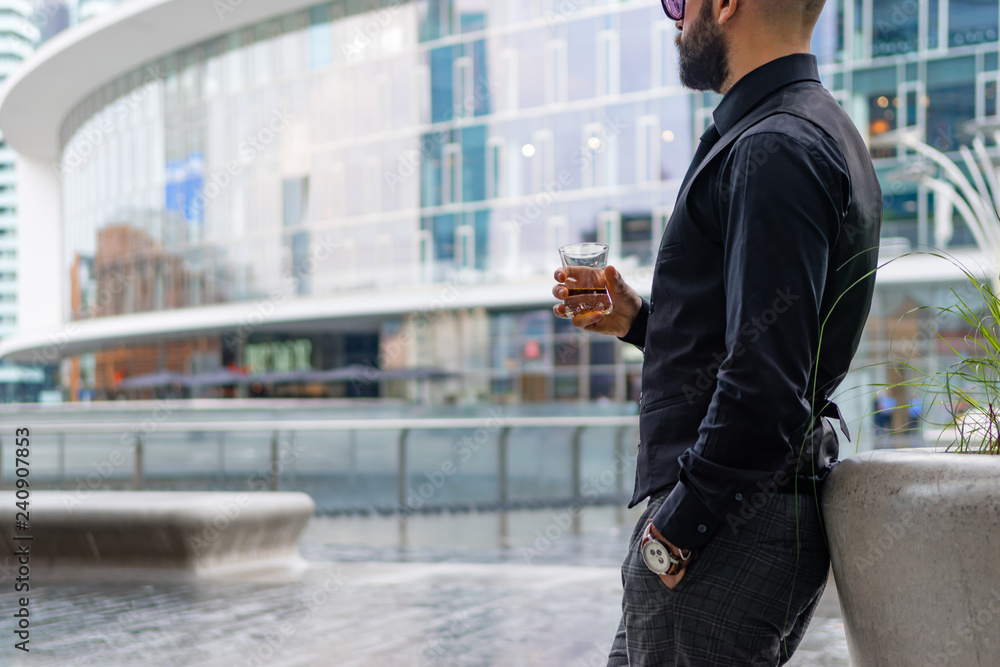 Fototapeta premium Man drinking a whiskey in Milan