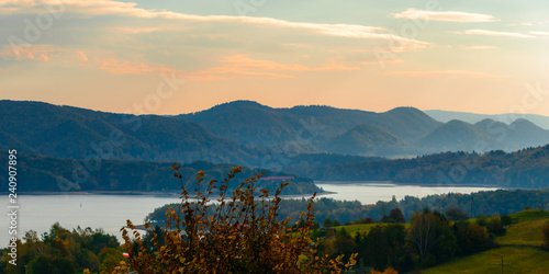 Fototapeta Naklejka Na Ścianę i Meble -  Polanczyk, Bieszczady Mountains, Poland: Sun rising over mountains. Views from near hill. In background Solina Lake.
