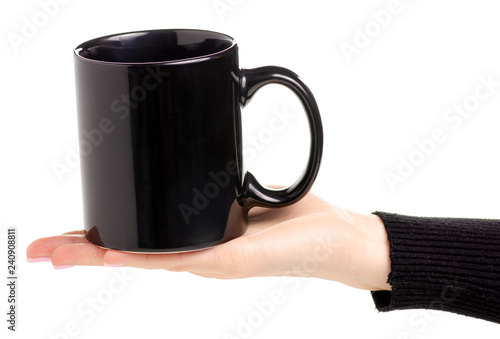 Black cup mug in female hand on white background isolation