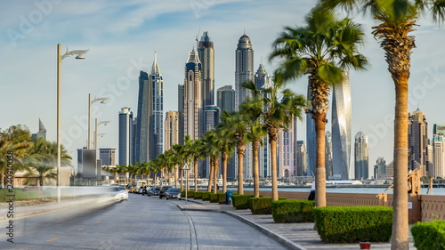 Waterfront promenade on the Palm Jumeirah with palms at road timelapse. Dubai, United Arab Emirates © neiezhmakov