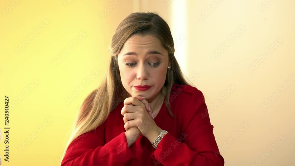 Luscious blonde in a red jacket performs office work, an office girl with big forms counts money on a calculator, counts bills, persuades a client to buy a product or service Luscious blonde in a red jacket performs office work, an office girl with big forms counts money on a calculator, counts bills, persuades a client to buy a product or service