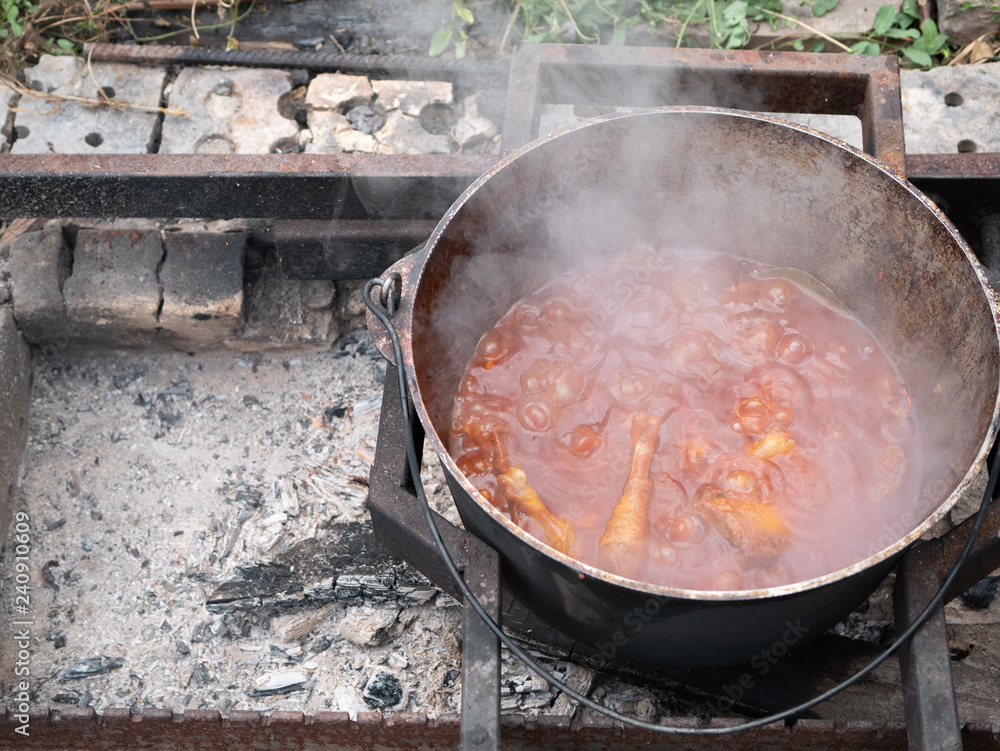 big heavy cauldron with vegetable meat stew big heavy cauldron with vegetable meat stew