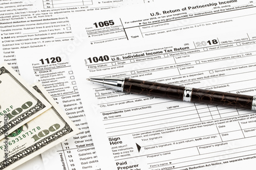 The tax forms with money and the pen. Tax Day concept