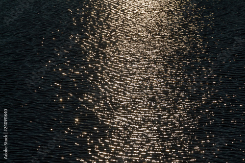 Obraz na plátně Water surface with ripples and sunrays reflections, Norilsk