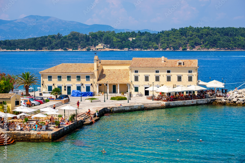 Beautiful island of Corfu and old houses in the foreground of the wonderful blue sea ( Kerkyra )
