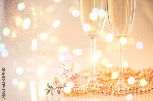 New Year Champagne glasses and fireworks background