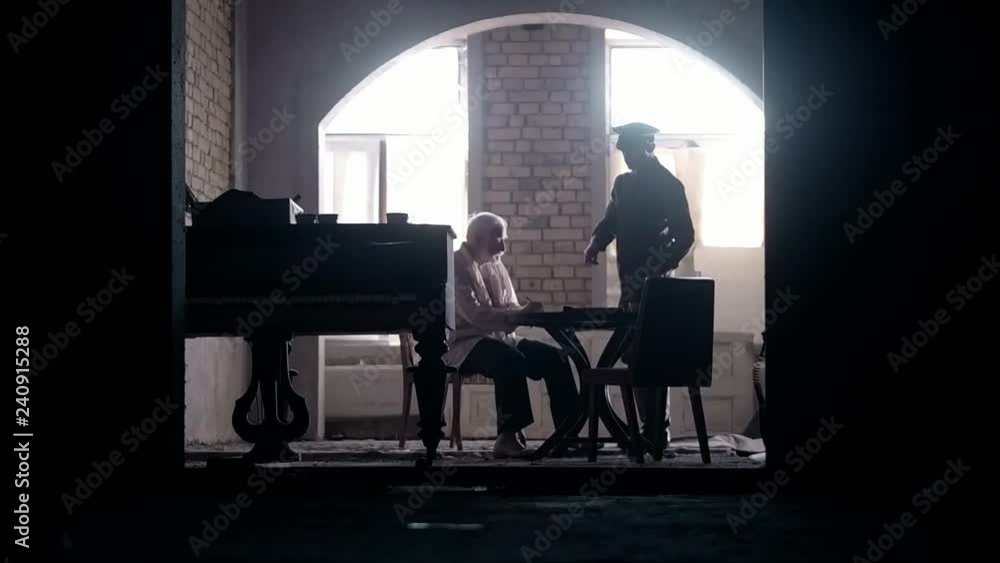 Soldier of the Russian army interrogates a suspect, an elderly man with a beard, under pain of execution, signs papers, the injustice of the NKVD, cynicism of the soldiers, the cruelty of the USSR Soldier of the Russian army interrogates a suspect, an elderly man with a beard, under pain of execution, signs papers, the injustice of the NKVD, cynicism of the soldiers, the cruelty of the USSR