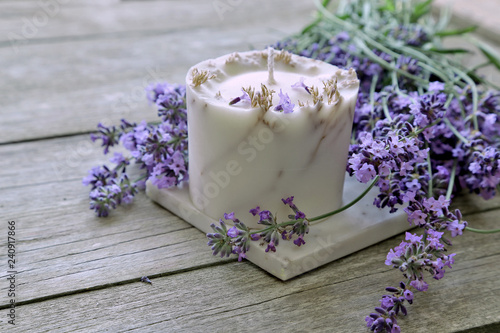 Fototapeta Naklejka Na Ścianę i Meble -  Lavender flowers  with candle on wooden background 