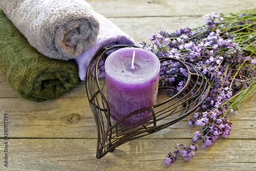 Fototapeta Naklejka Na Ścianę i Meble -  Lavender flowers with candle and towel on wooden background 