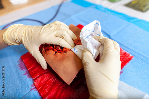 German military medic practice bleeding control on a wound dummy