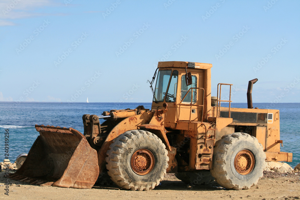 A bulldozer and a panoramic view of the Mediterranean sea from the Limassol seafront A bulldozer and a panoramic view of the Mediterranean sea from the Limassol seafront
