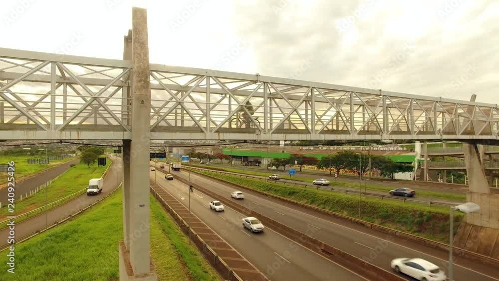 Pedestrian bridge over a highway in Ribeirao Preto (Brazil). Footbridge, overpass, people using pedestrian crossing. Pedestrian bridge over a highway in Ribeirao Preto (Brazil). Footbridge, overpass, people using pedestrian crossing.