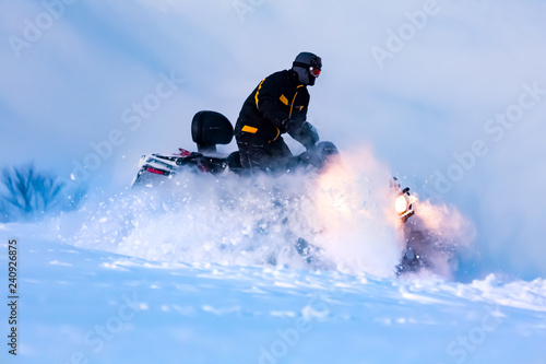 A man is riding snowmobile.