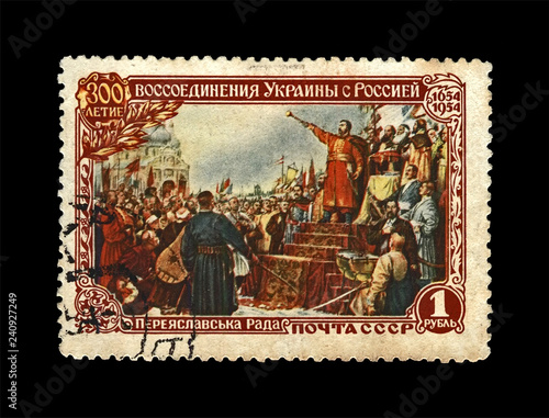 hetman Bogdan Khmelnitsky proclaming reunion of Ukraine and Russia during Pereyaslav Council in 1654, circa 1954. canceled vintage stamp printed in USSR isolated on black background. 