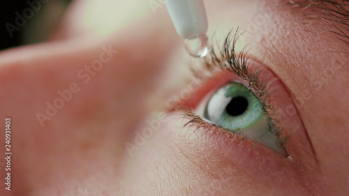 macro close up eye using eyedrops liquid medicine healthy eyesight clarity concept photo