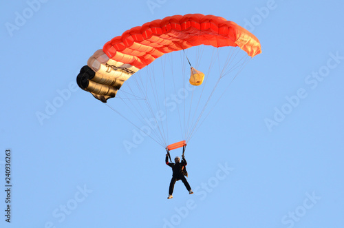 Parachutist going to land. Man jumping parachute.