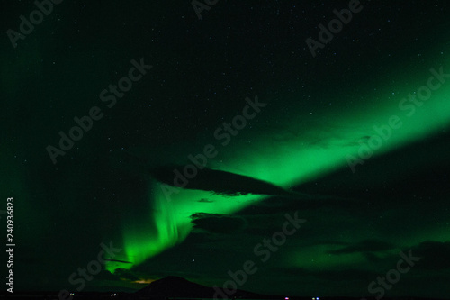 Winter scenic landscape night view of  Aurora Borealis Northern lights dancing on the clear sky full of stars above lake Myvatn  north Iceland Beautiful winter wonderland fairytale background scene. 