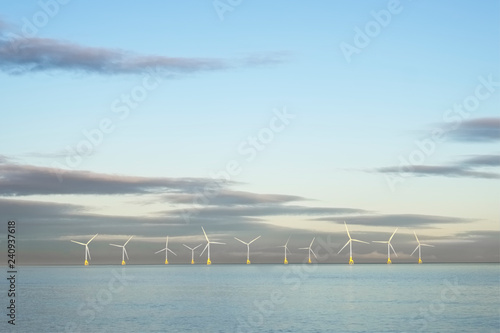 Fotografie Wind farm in north sea ocean floating turbines on horizon offshore at Aberdeen t